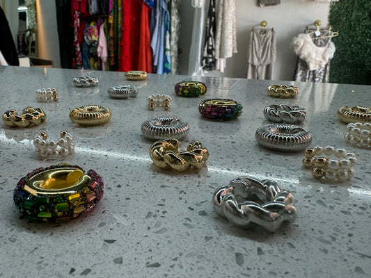 Gold- and silver-tone hoop earrings with colorful stone accents on display