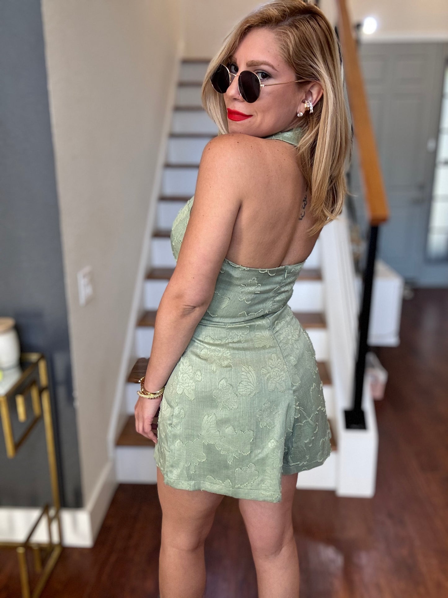 Light green halter romper with low back and V-shaped waistband