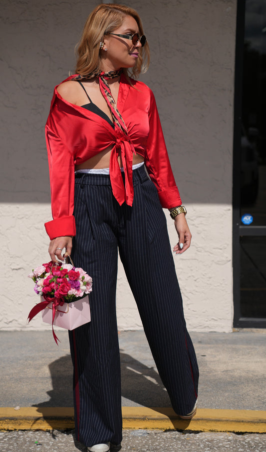 Pinstriped high-waist wide-leg trousers in dark navy with red piping along seams