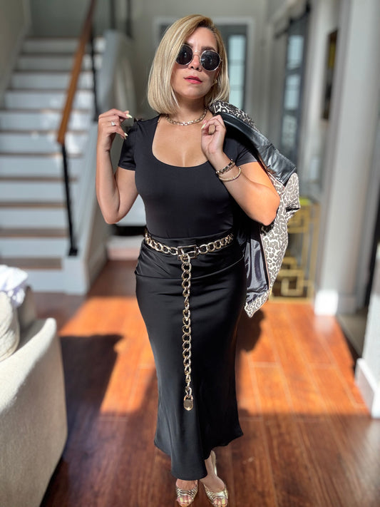 Black midi skirt with fitted silhouette and column-like drape