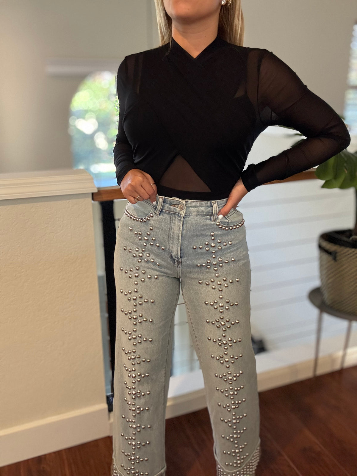 Light-wash studded jeans with silver-tone dots on front seams and hip area