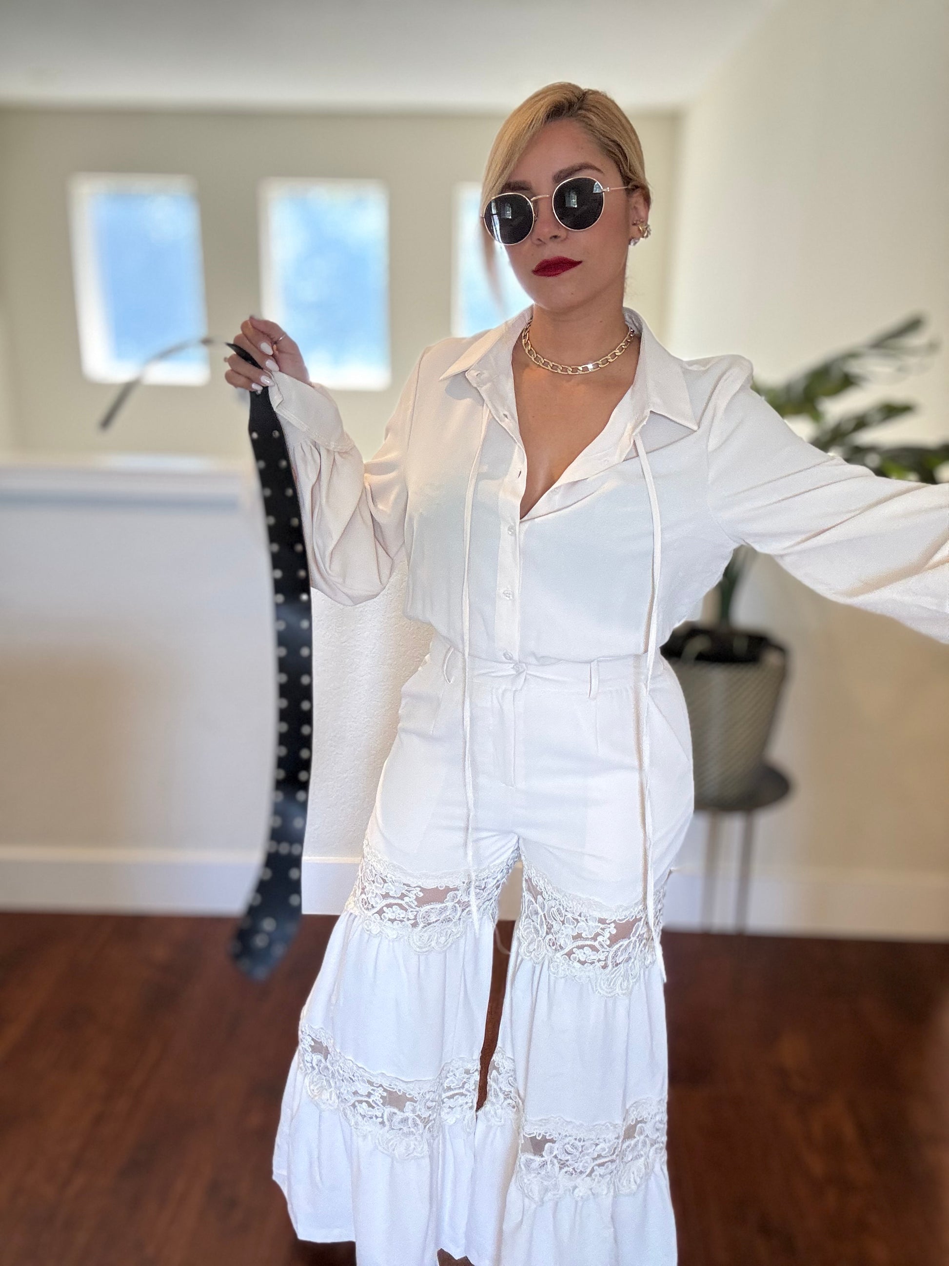 White button-front lace-trim jumpsuit with long sleeves and tiered skirt hem