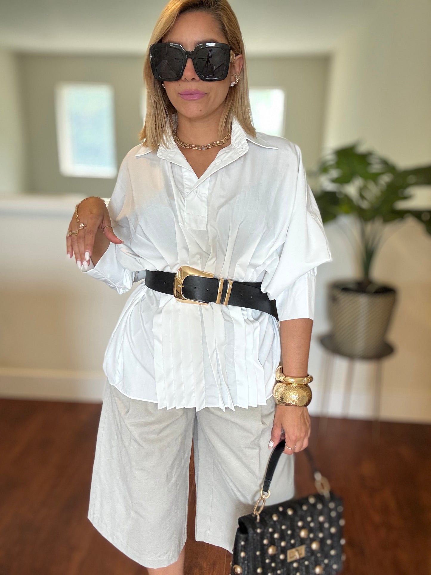 White button-up peplum top with short sleeves and pleated front detail