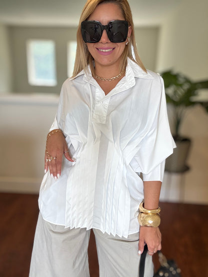 White button-up peplum top with short sleeves and structured collar