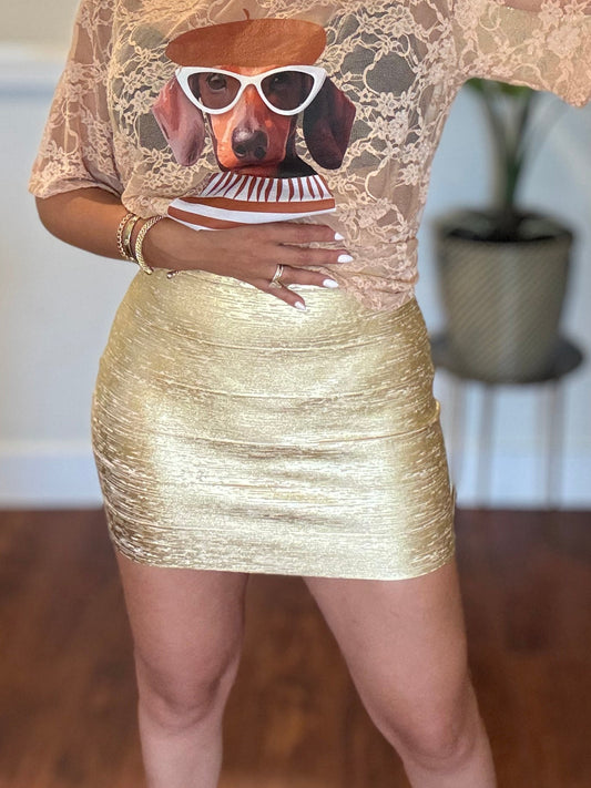 Gold metallic fitted mini skirt with textured shine and straight hem