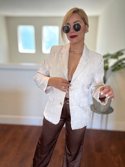 Ivory textured blazer with two flap pockets and gold button closure