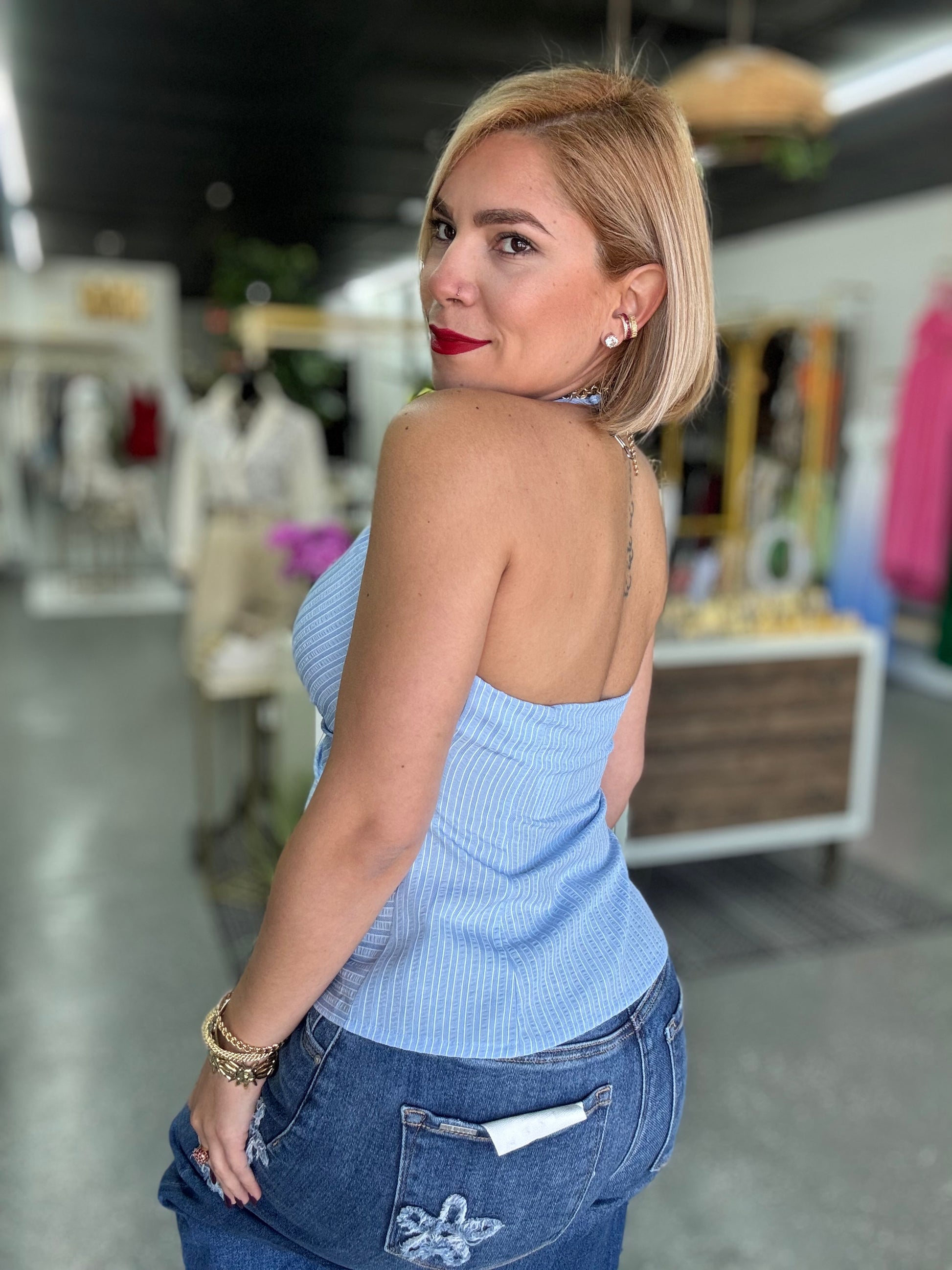 Light blue halter top with open back and gathered fabric, two-button front