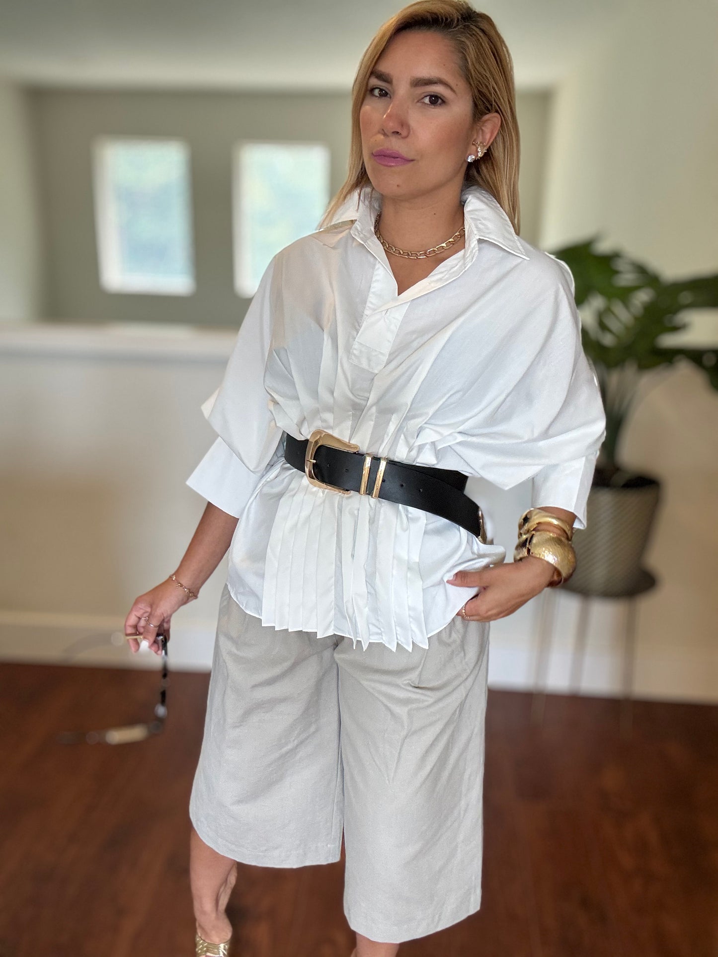 White button-up peplum top with short sleeves and ruffled front hem