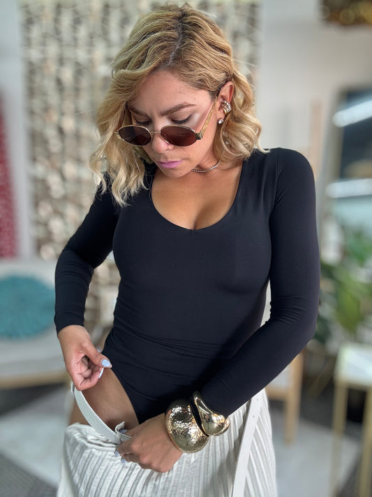 Black long-sleeve bodysuit with low V/scoop neckline, body-hugging fit