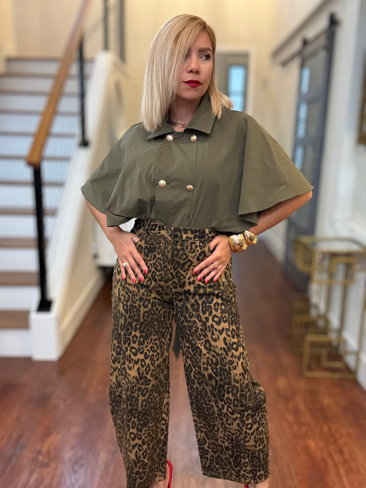 Olive green cape-style short-sleeve top with double-breast button front and pointed collar