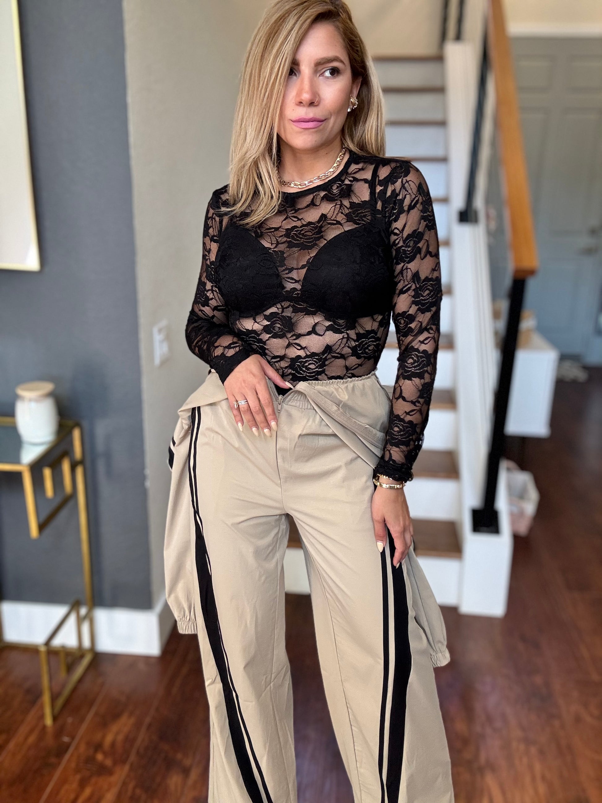 Bianca Fly jumpsuit with black lace long sleeves and beige pants with black side stripe