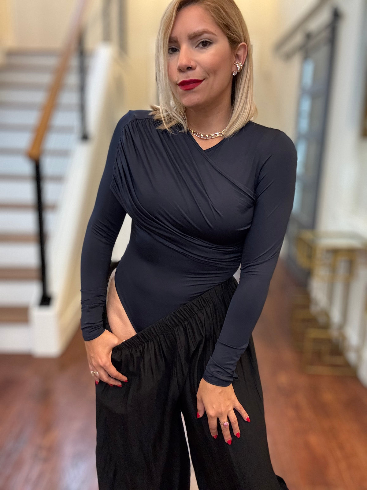 Dark blue long-sleeve bodysuit with wrap V-neck and ruched cross-body seam