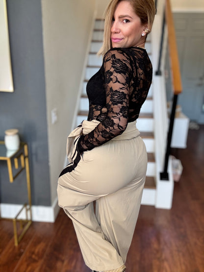 Bianca Fly jumpsuit with black lace long sleeves and beige pants with gathered waist