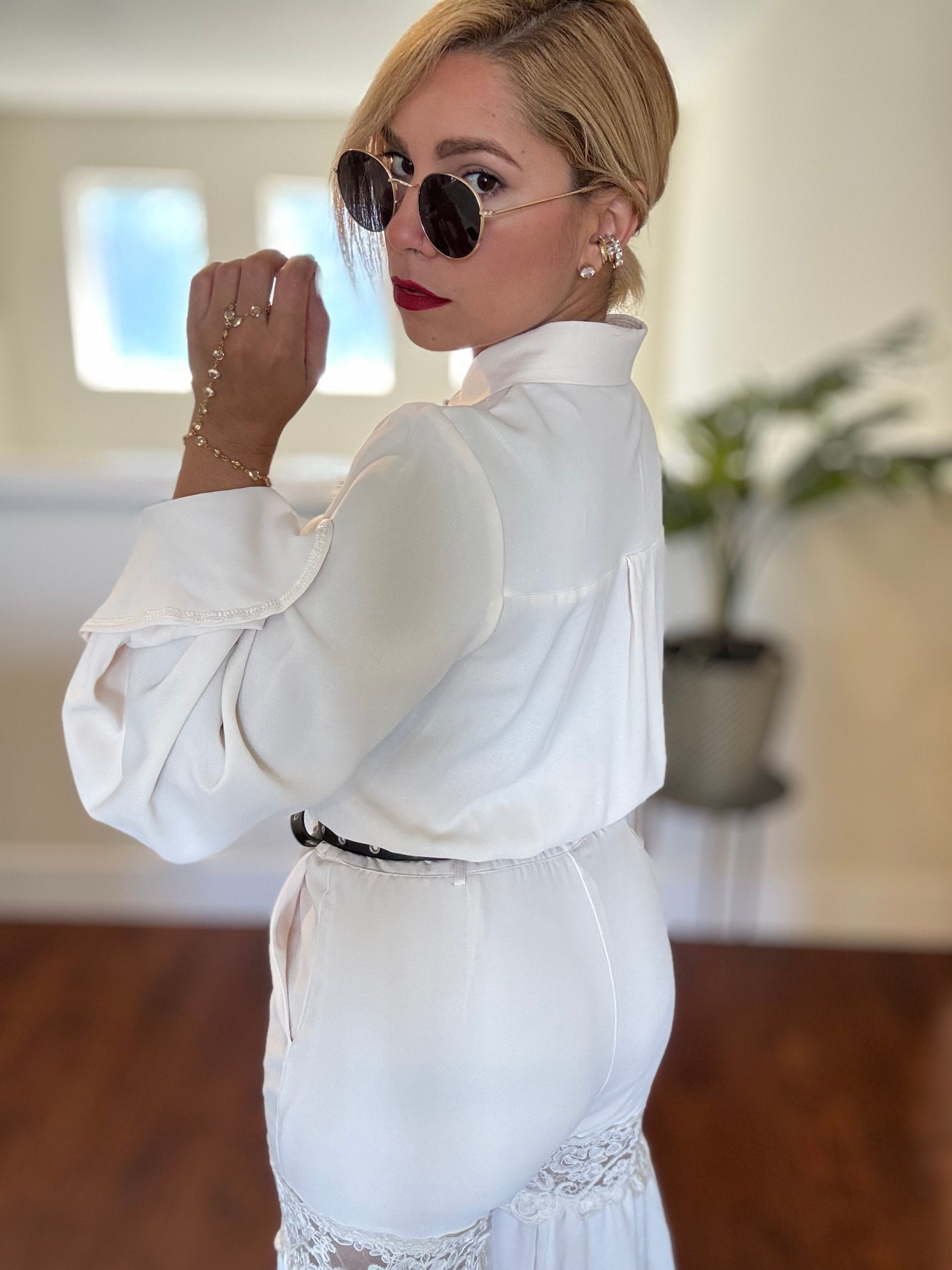 White sleeveless jumpsuit back view with high collar and lace tiered waist hem