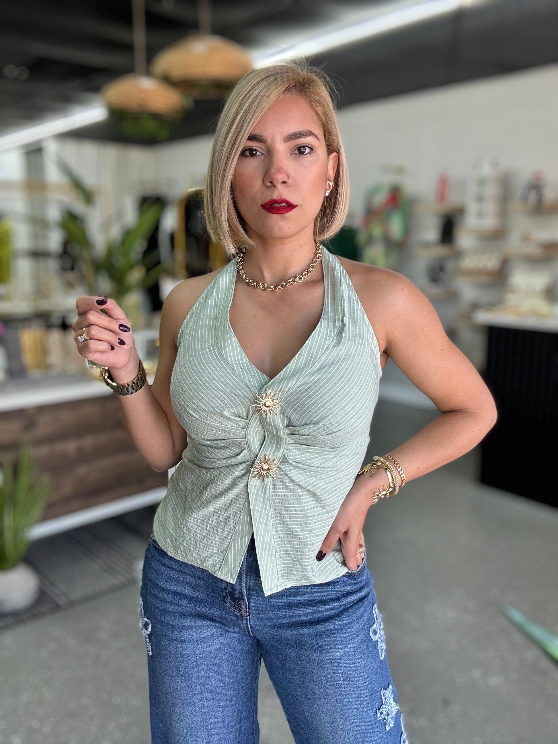 Light green halter top with deep V front, gathered seam and gold button detail