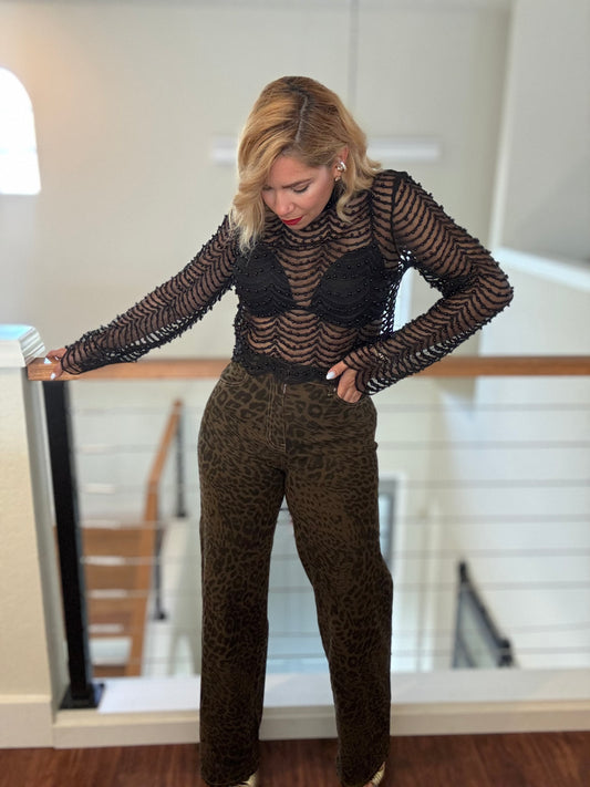Leopard-print jeans in dark brown with black animal print, angled side view