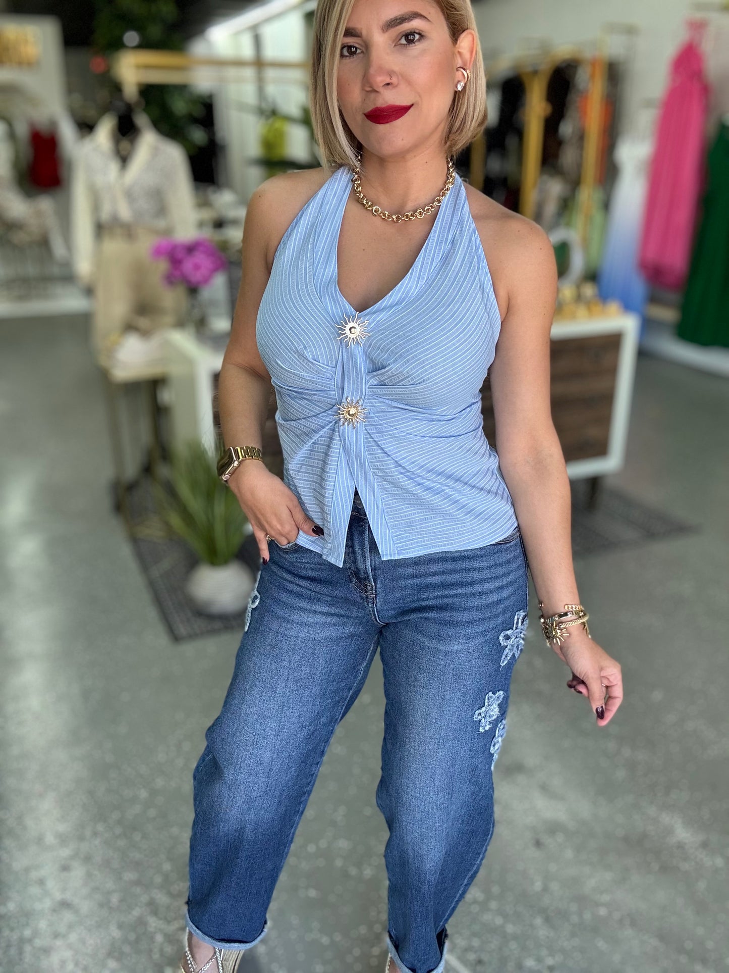 Light blue halter top with ruched front and two gold-tone buttons, sleeveless