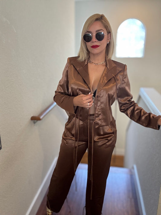 Brown satin jumpsuit with V-neck collar, zip front, long sleeves and tapered legs