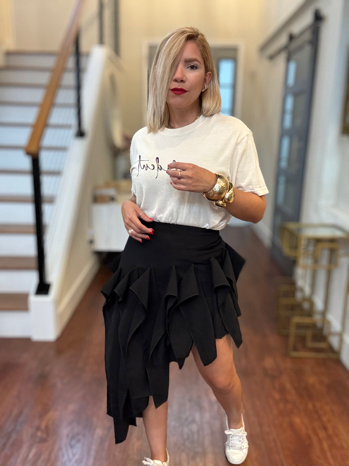 Black ruffle tier mini skirt with fitted waist and layered scallops