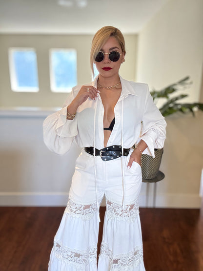 White button-front lace jumpsuit with long sleeves and deep V neckline plus belt
