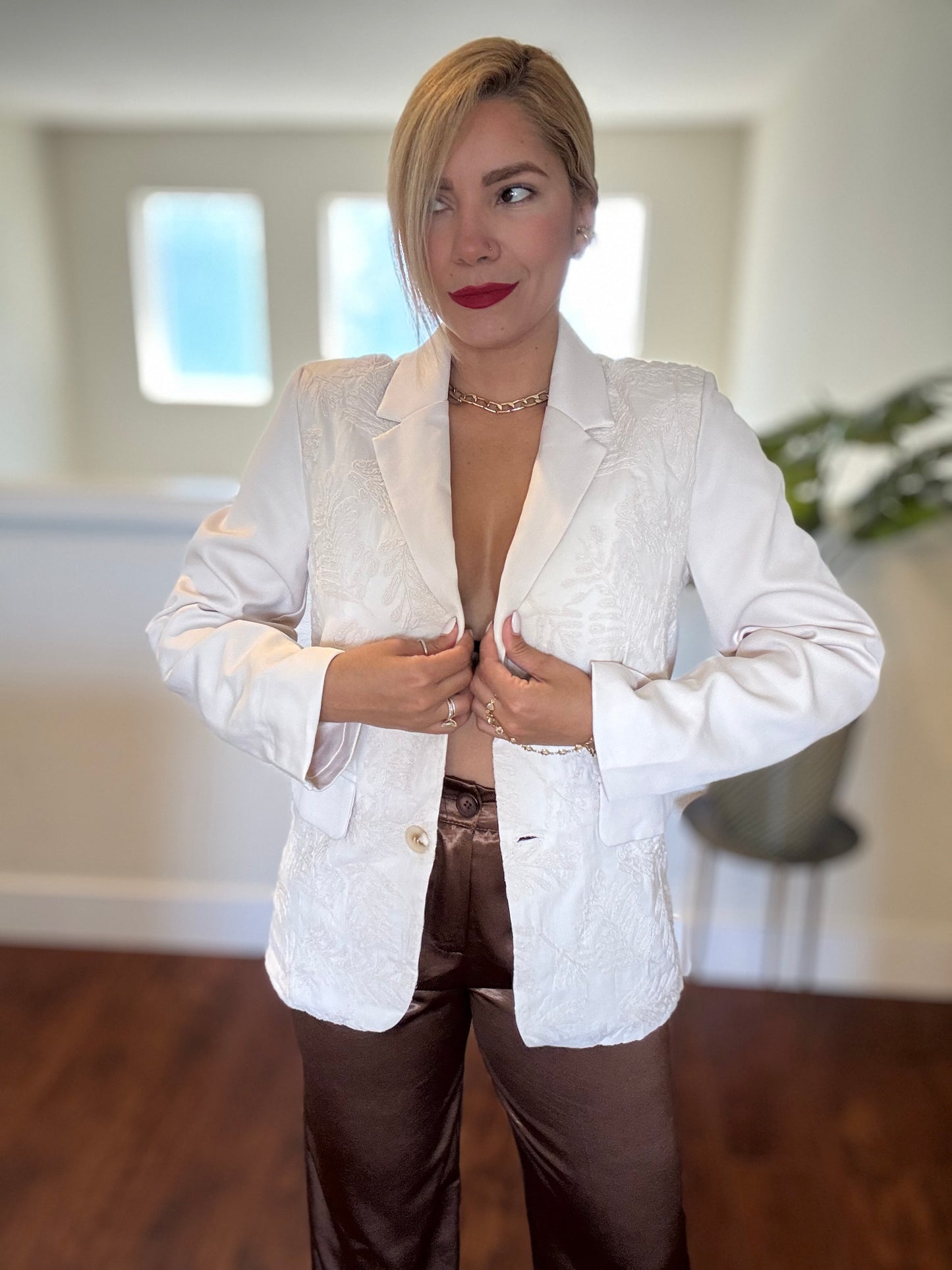 Ivory textured blazer with notch lapels and gold button front, sleeves adjusted