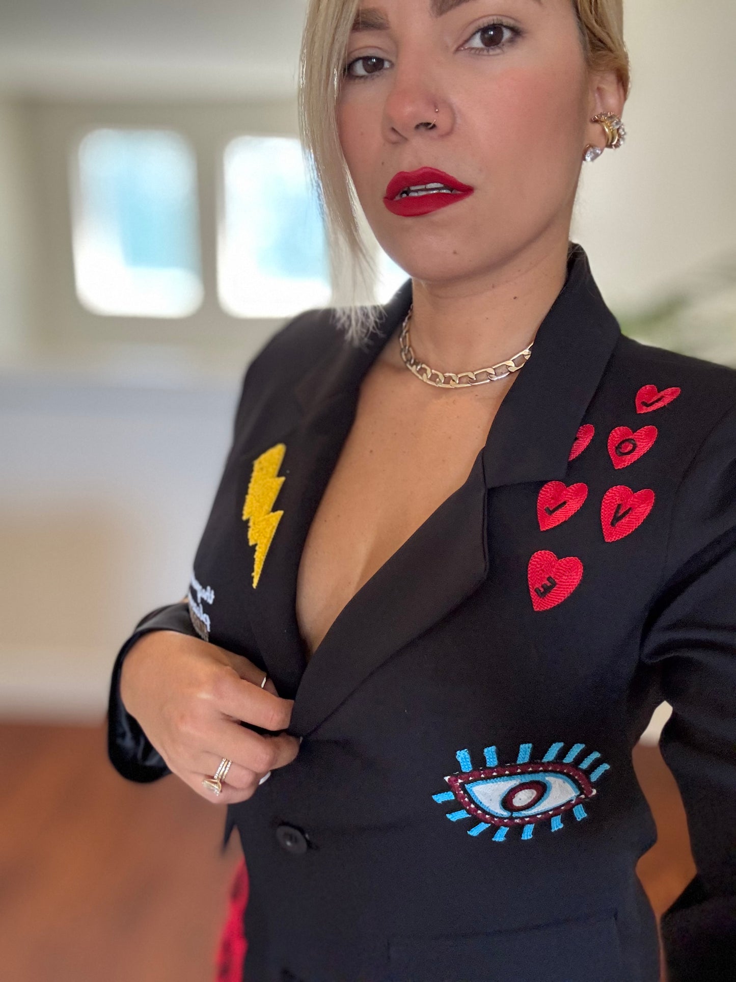 Black blazer close-up with heart and eye patch details