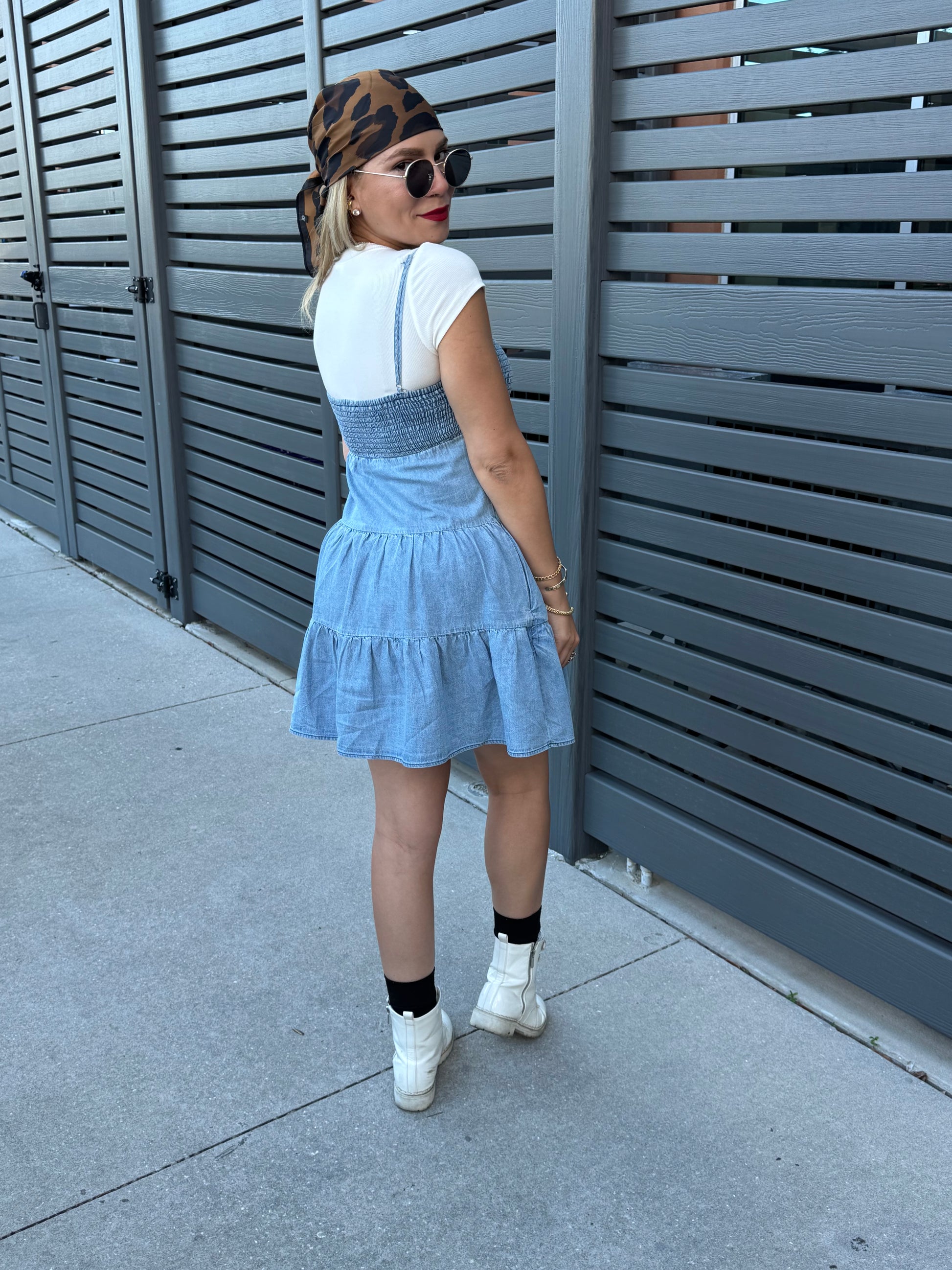 Two-tone light blue dress with white cap sleeves and tiered ruffles, back-side angle