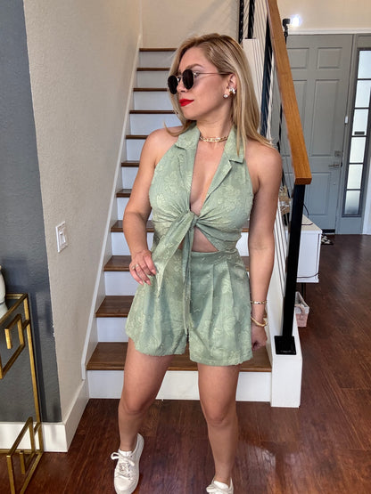 Light green halter romper with bow-tie front and deep V neckline