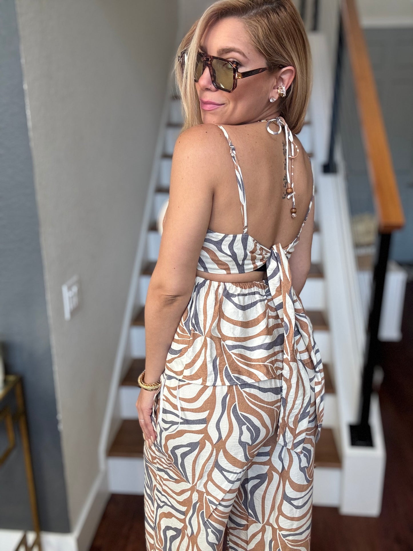 Alicia set sleeveless animal-print jumpsuit with open back and adjustable shoulder ties