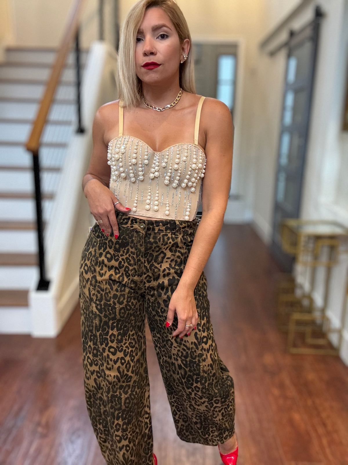 Pearl heart bustier with dangling bead fringe and thin straps, worn with leopard pants