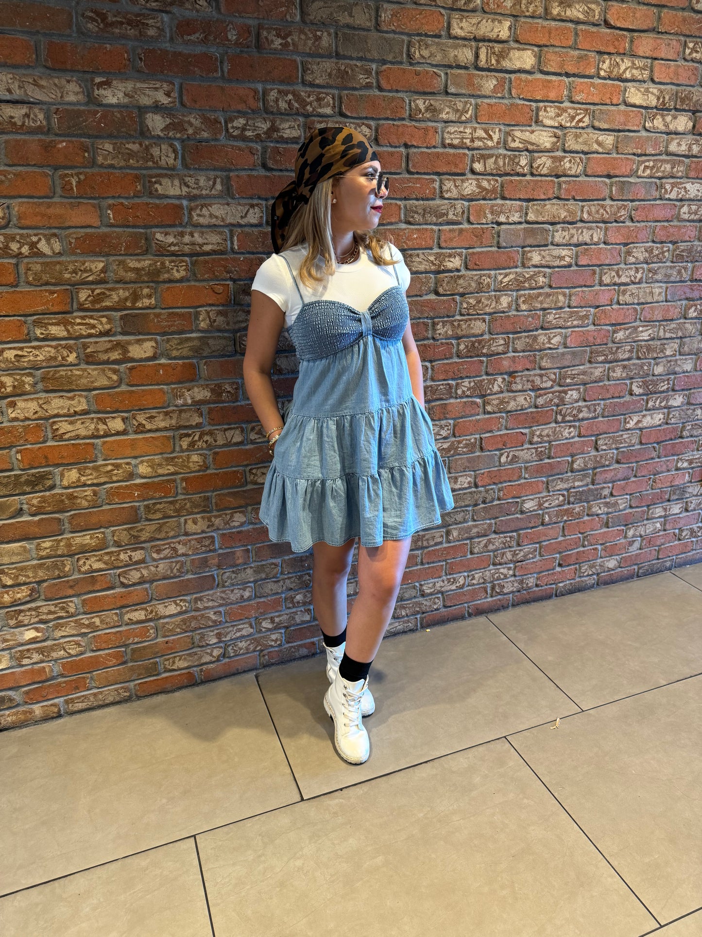 Two-tone light blue dress with white cap sleeves and tiered ruffle hem, standing view