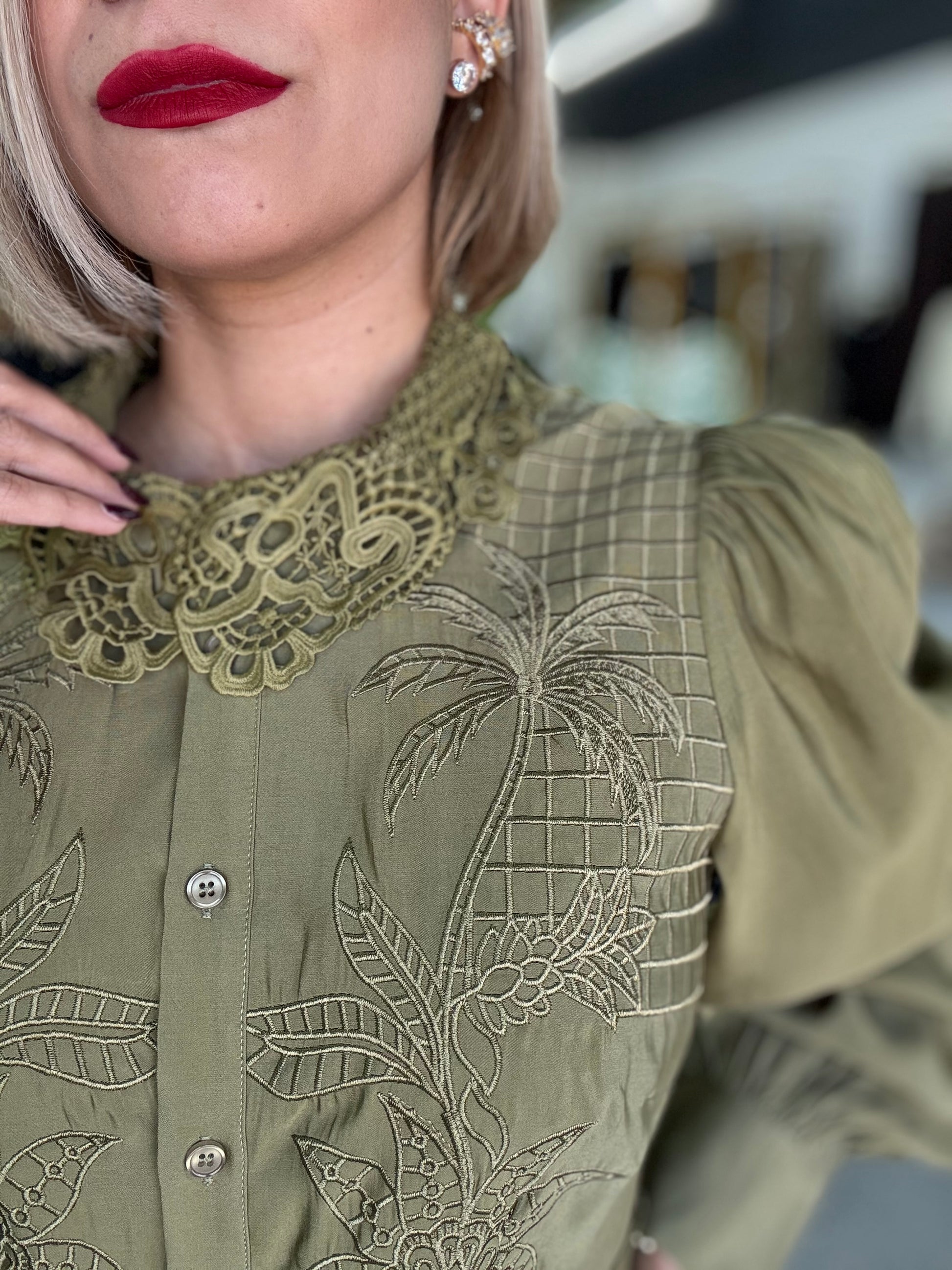 Olive green button-front blouse with lace collar and embroidered floral grid design