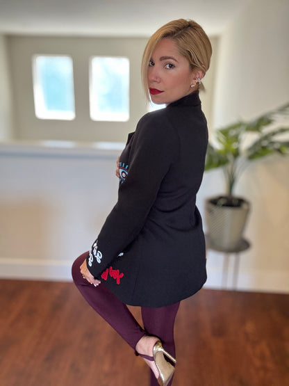 Black blazer with colorful patches, notch lapels, and single-breasted front