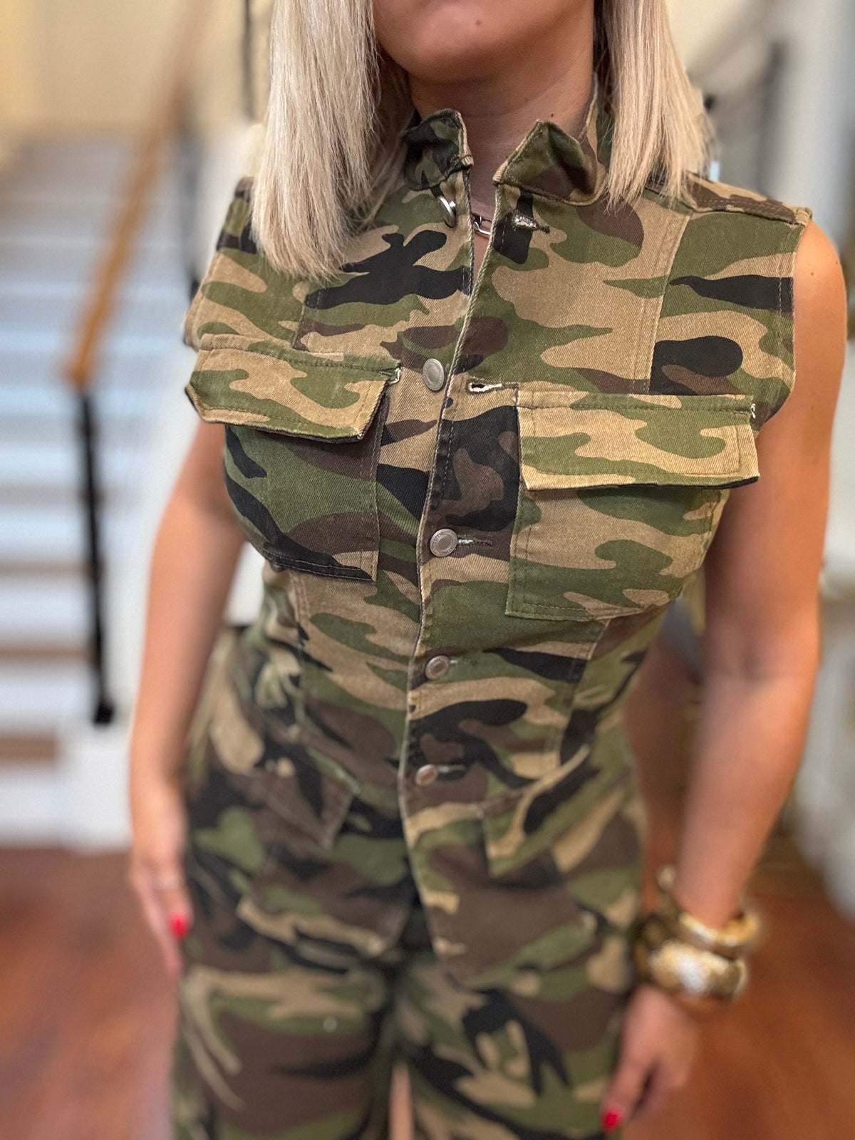 Camo sleeveless button-front vest with flap pockets and chest yoke seams