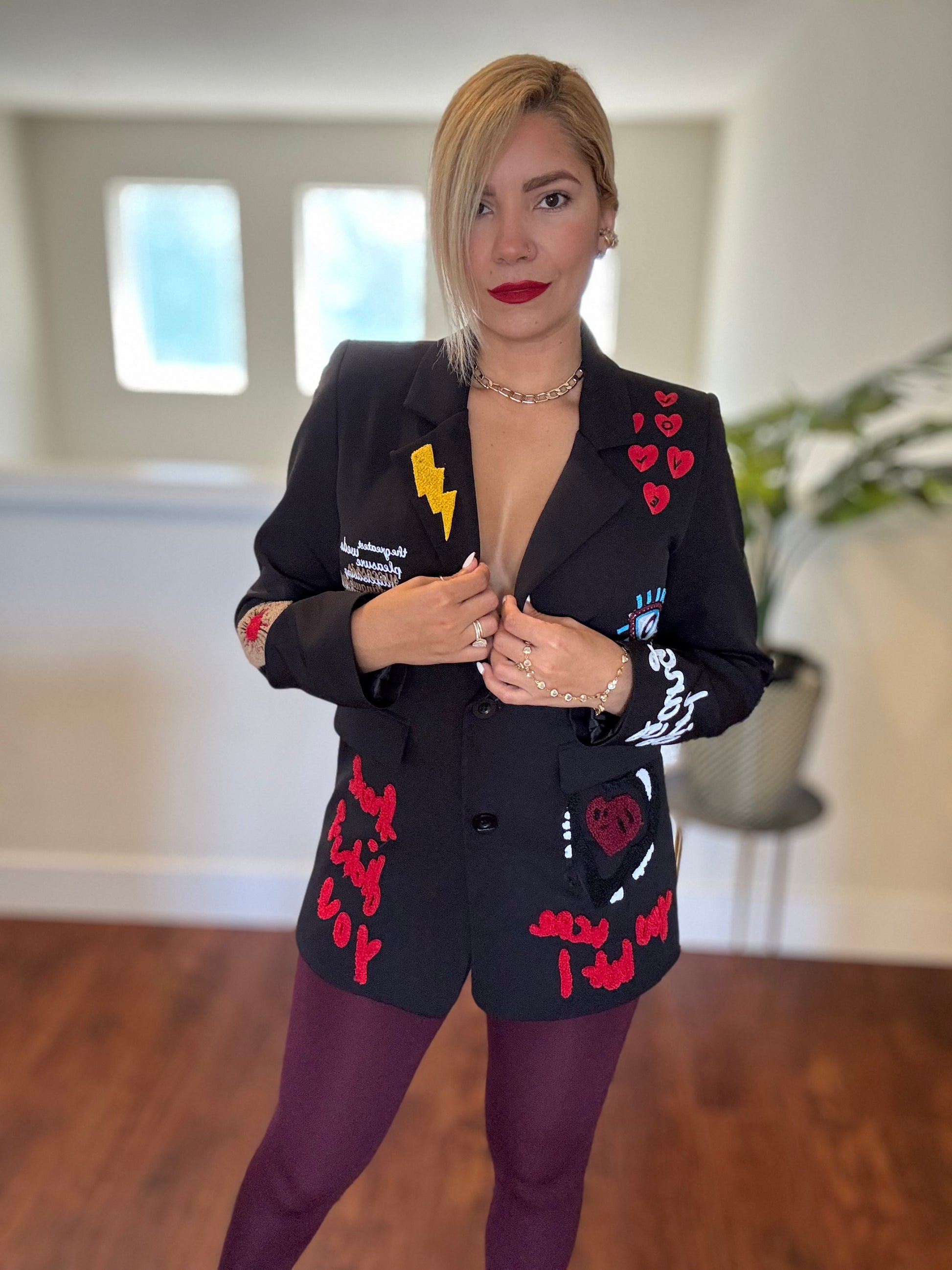 Black blazer with scattered heart patches and graphic sleeve prints