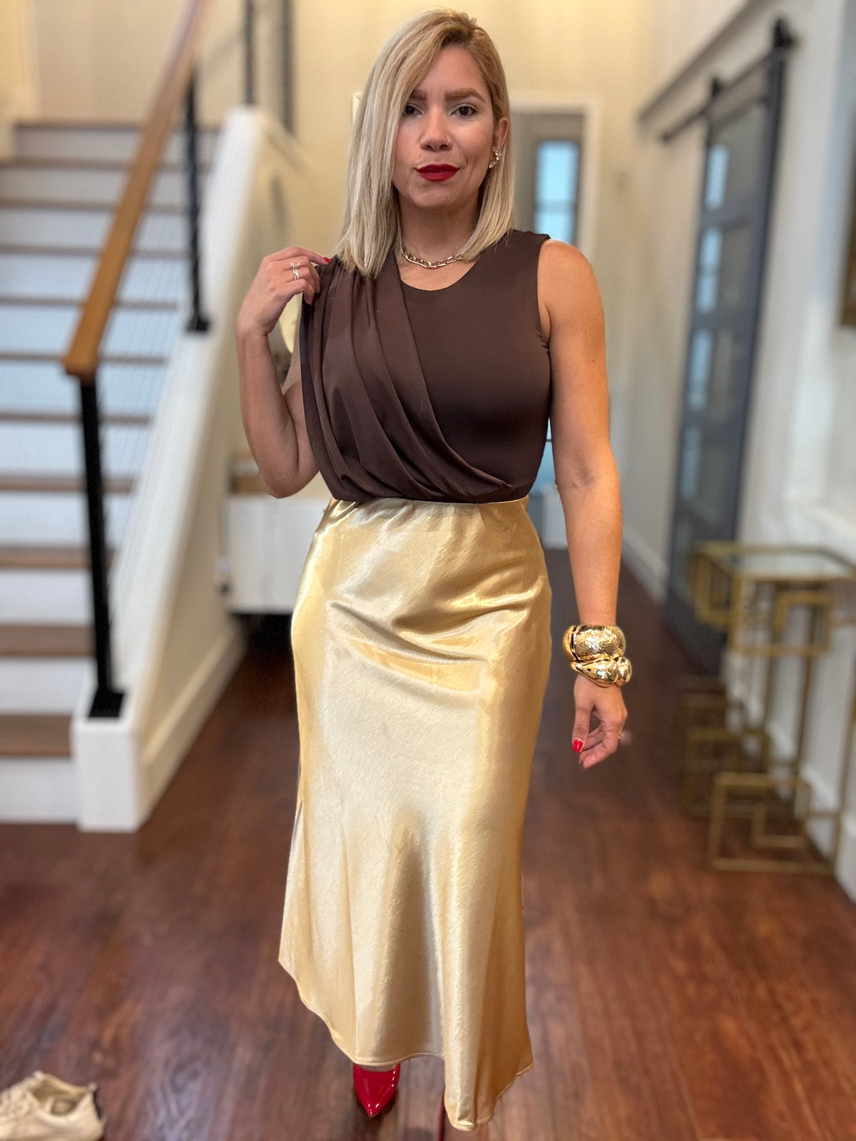 Mocha sleeveless bodysuit with high round neckline, fitted silhouette