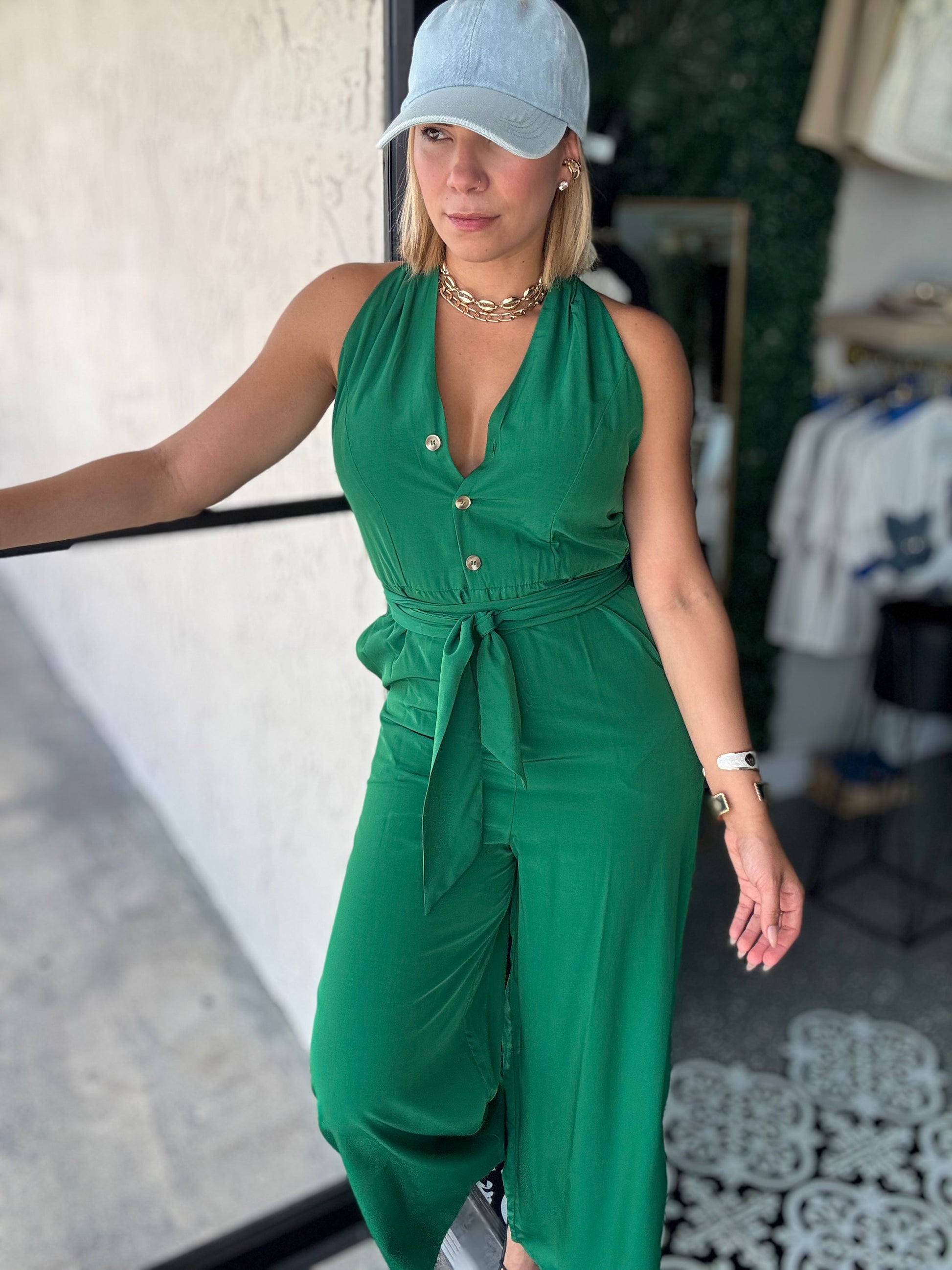 Emerald green sleeveless jumpsuit with button front and cinched waist, wide legs