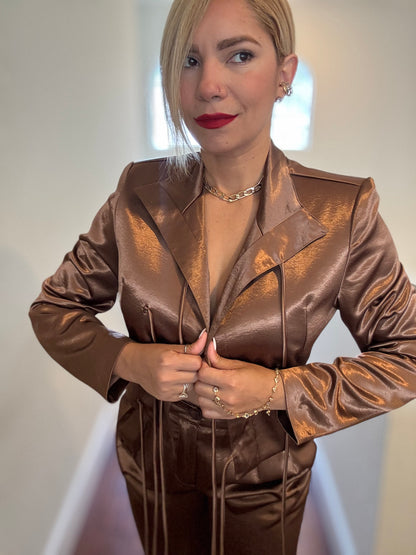 Bronze satin jumpsuit with deep V neckline and buttoned front with drawstring tie