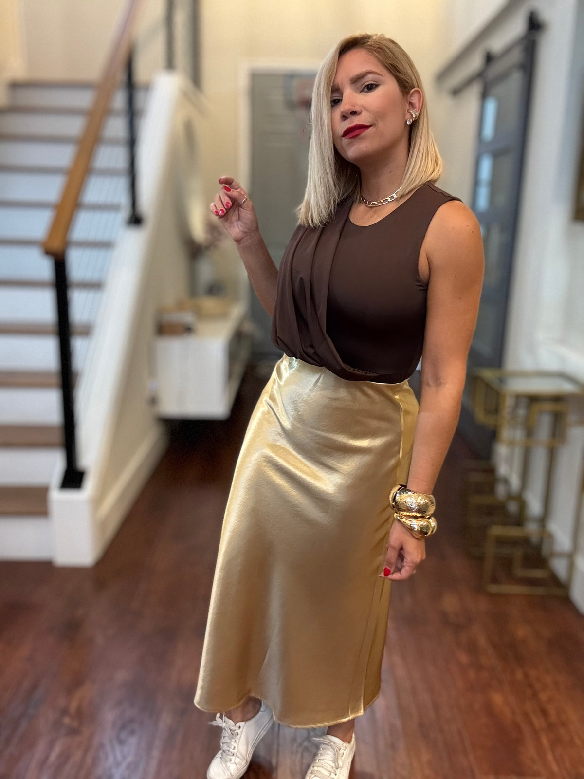 Gold satin midi skirt with fluid movement and softly flared hem