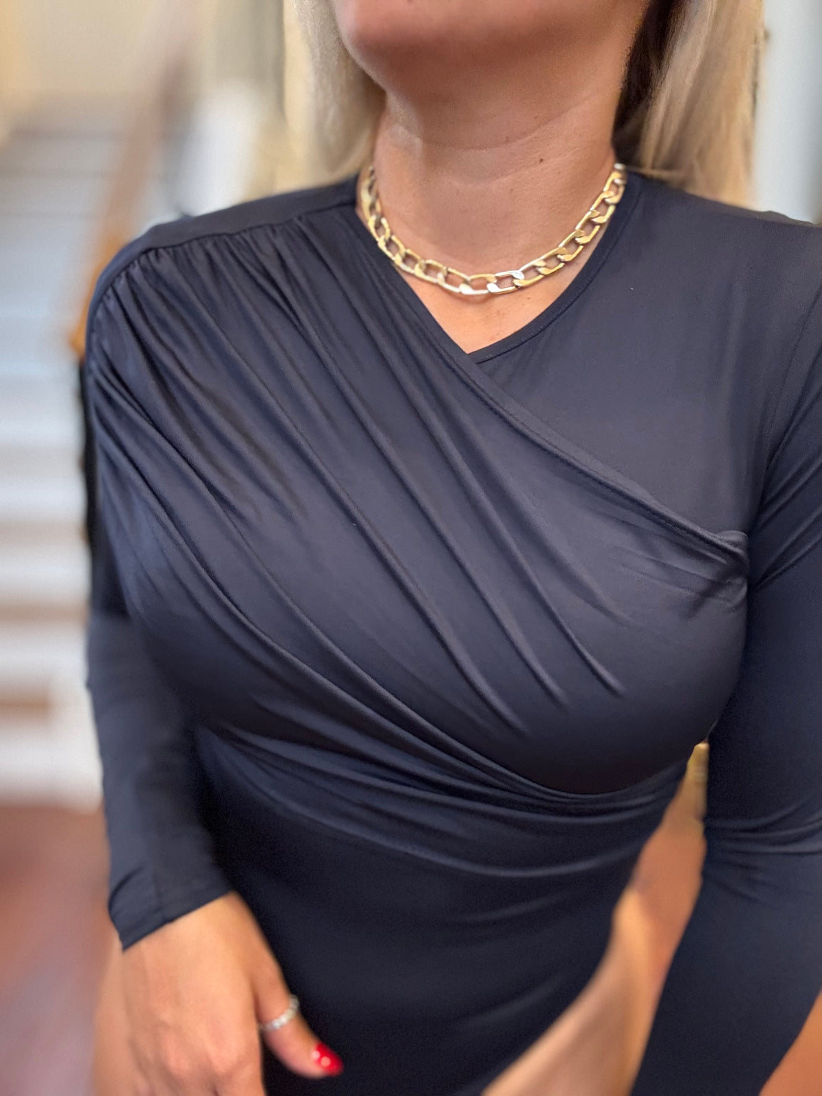 Dark blue long-sleeve bodysuit with ruched wrap-style V-neck and fitted silhouette