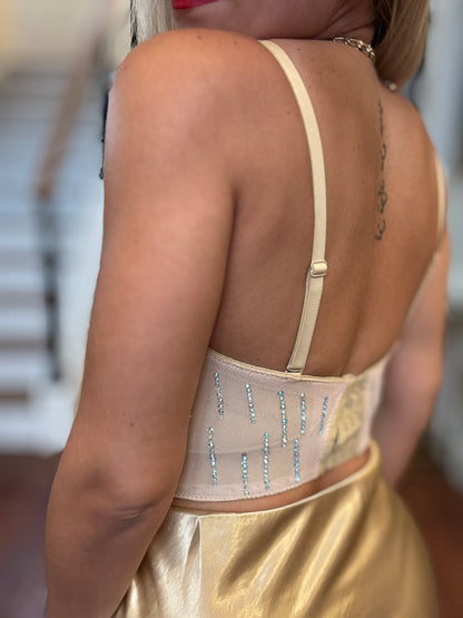 Back of pearl heart bustier with nude straps and dangling bead fringe at hem
