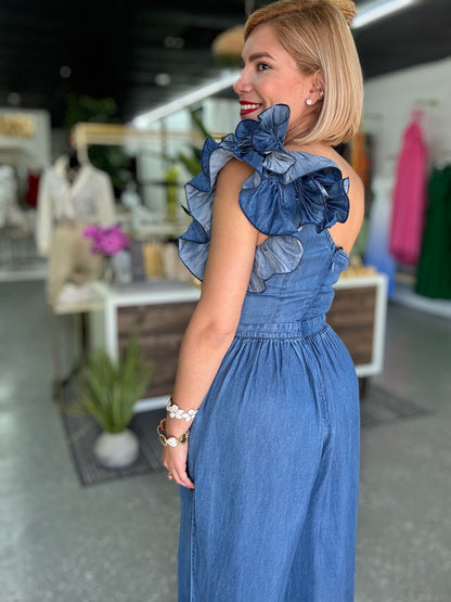 Blue denim one-shoulder jumpsuit with oversized ruffle collar at the shoulder