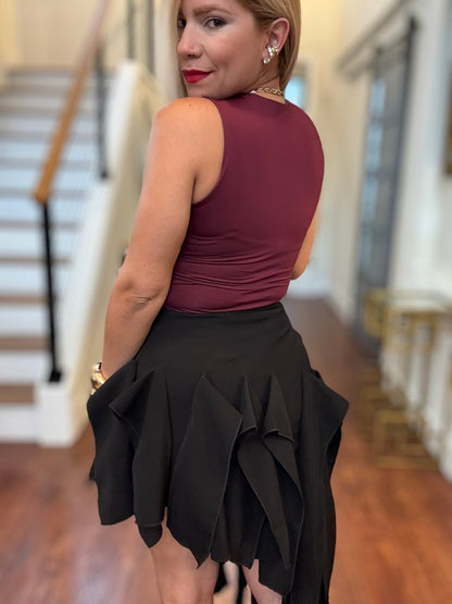 Burgundy sleeveless bodysuit with black ruffled layered skirt, back view