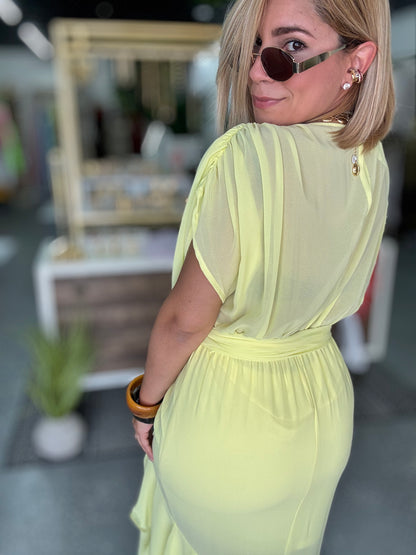 Yellow ruffled V-neck belted dress with tiered skirt, upper body close-up