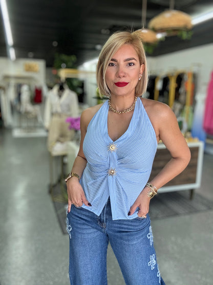 Light blue halter top with V-neck, gathered front, and two gold-tone button details