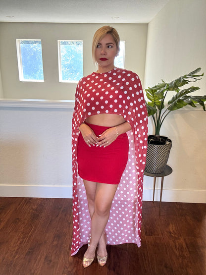 Red crop top and fitted mini skirt with white polka-dot sheer wrap around shoulders.