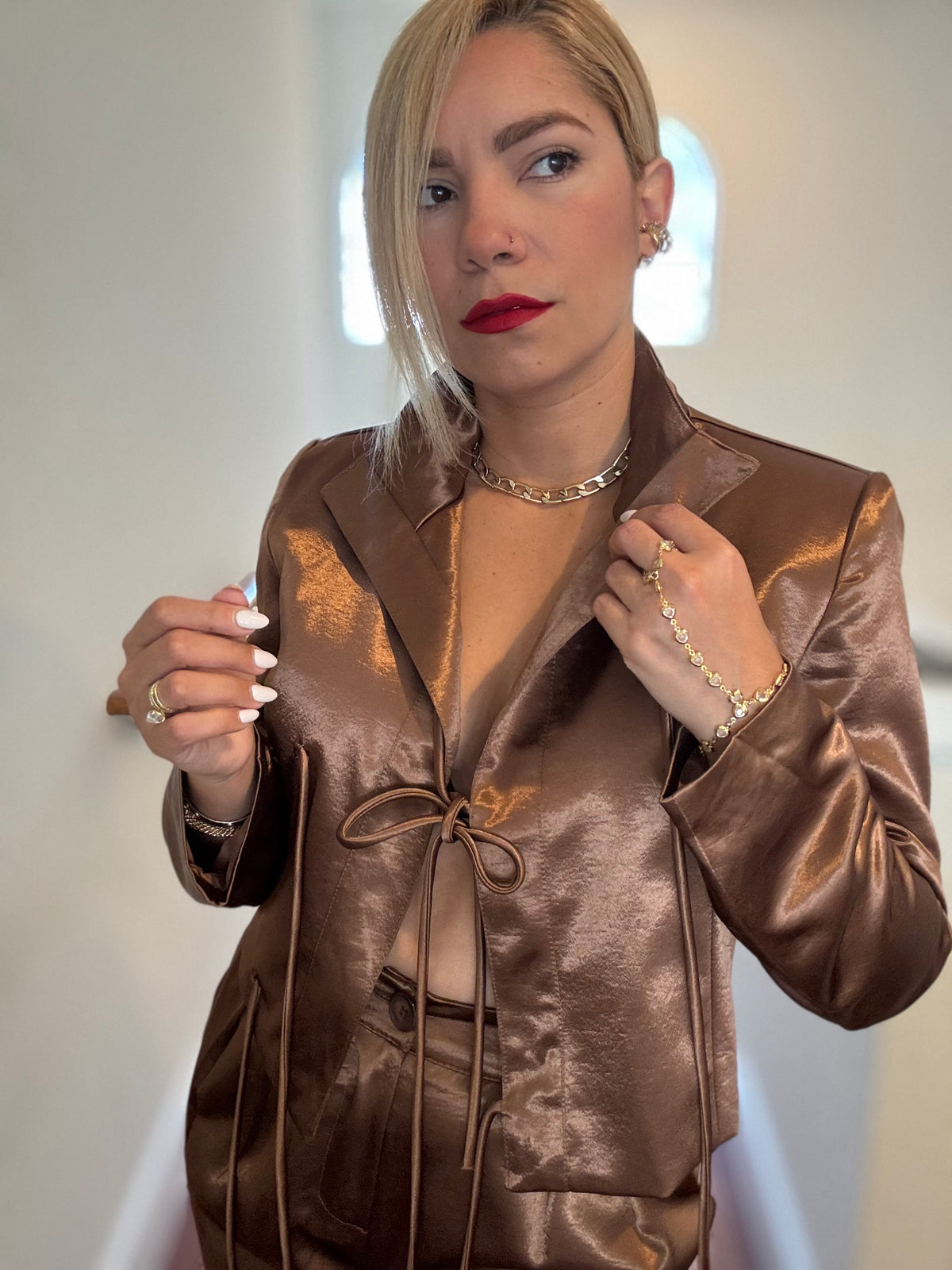 Bronze satin jumpsuit with open collar and drawstring tie at the waist