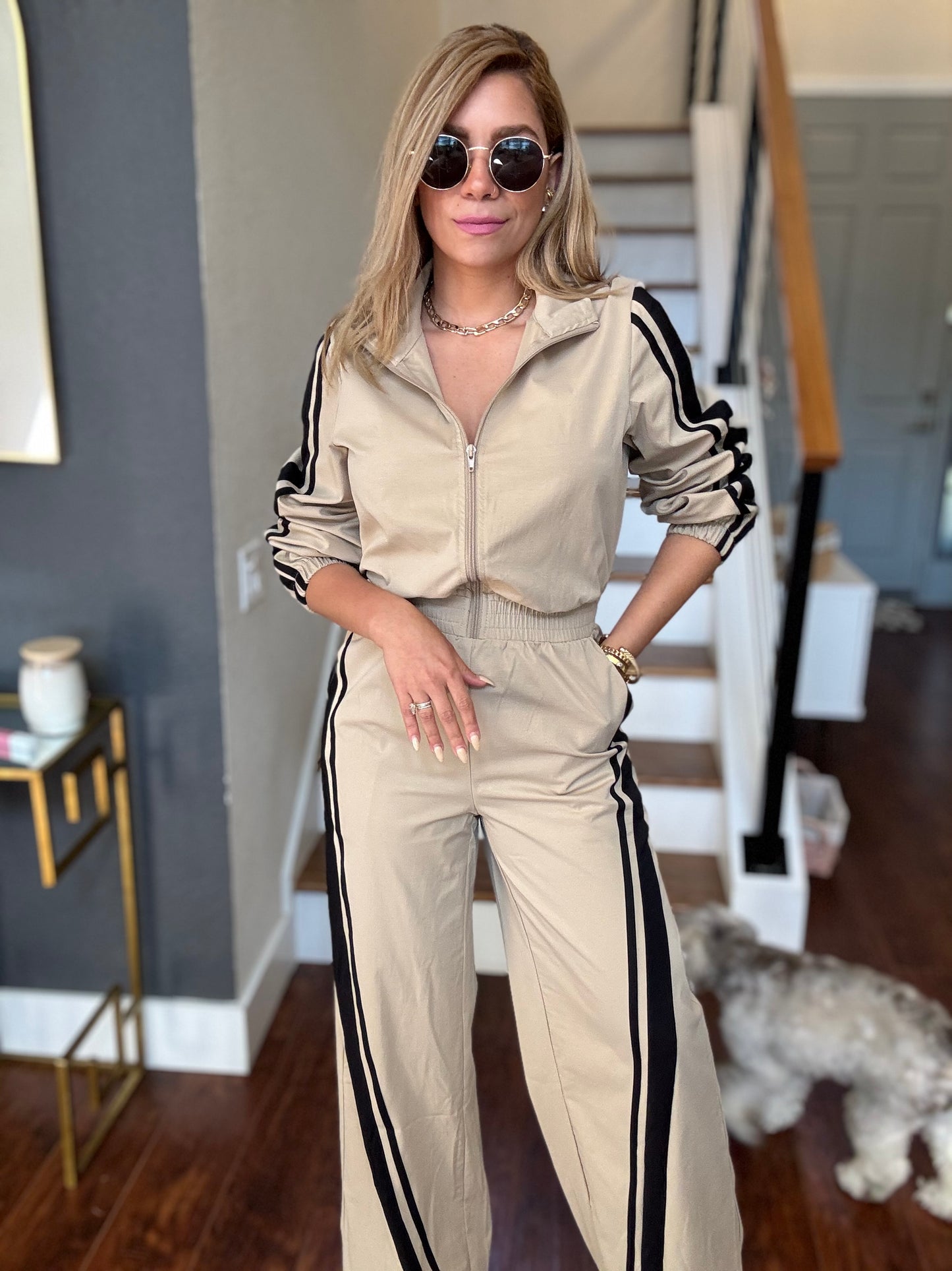 Bianca Fly jumpsuit in beige with hooded zip front and black side stripe down the legs