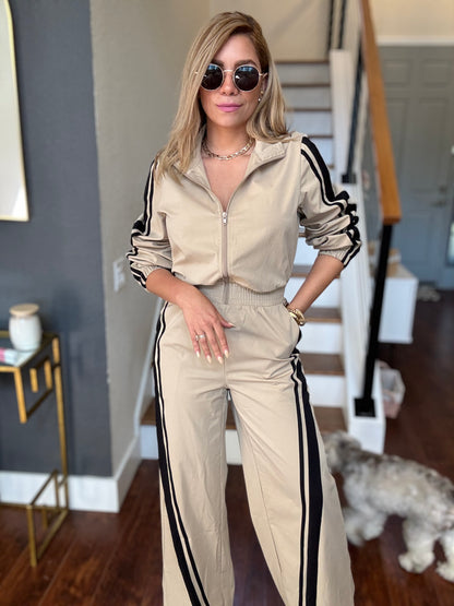 Bianca Fly jumpsuit in beige with hooded zip front and black side stripe down the legs