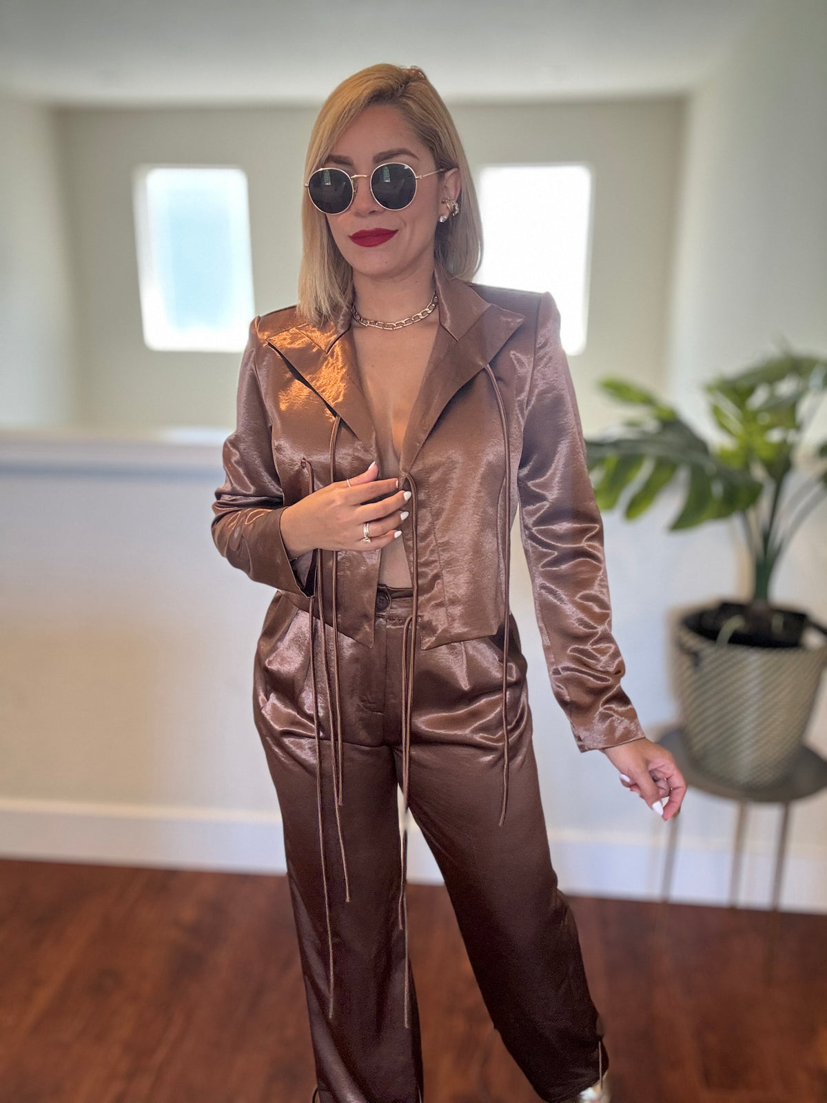 Brown satin jumpsuit with zip front, notch collar, long sleeves and tapered pants